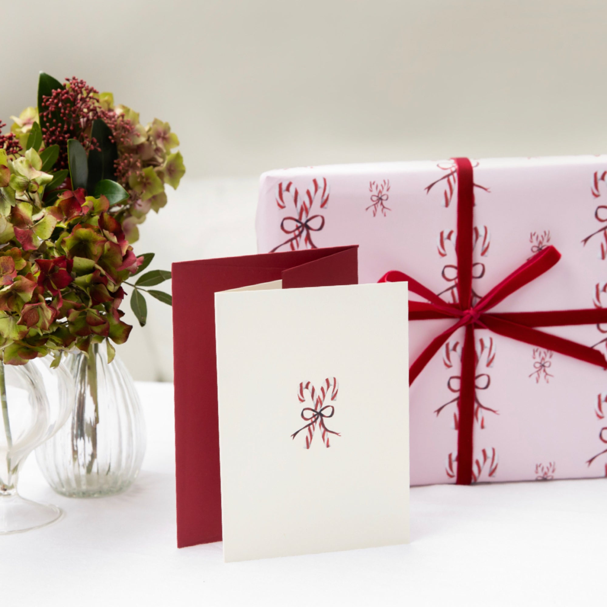Luxury Christmas Card with an illustration of a pair of candy canes tied in a bow by Memo Press
