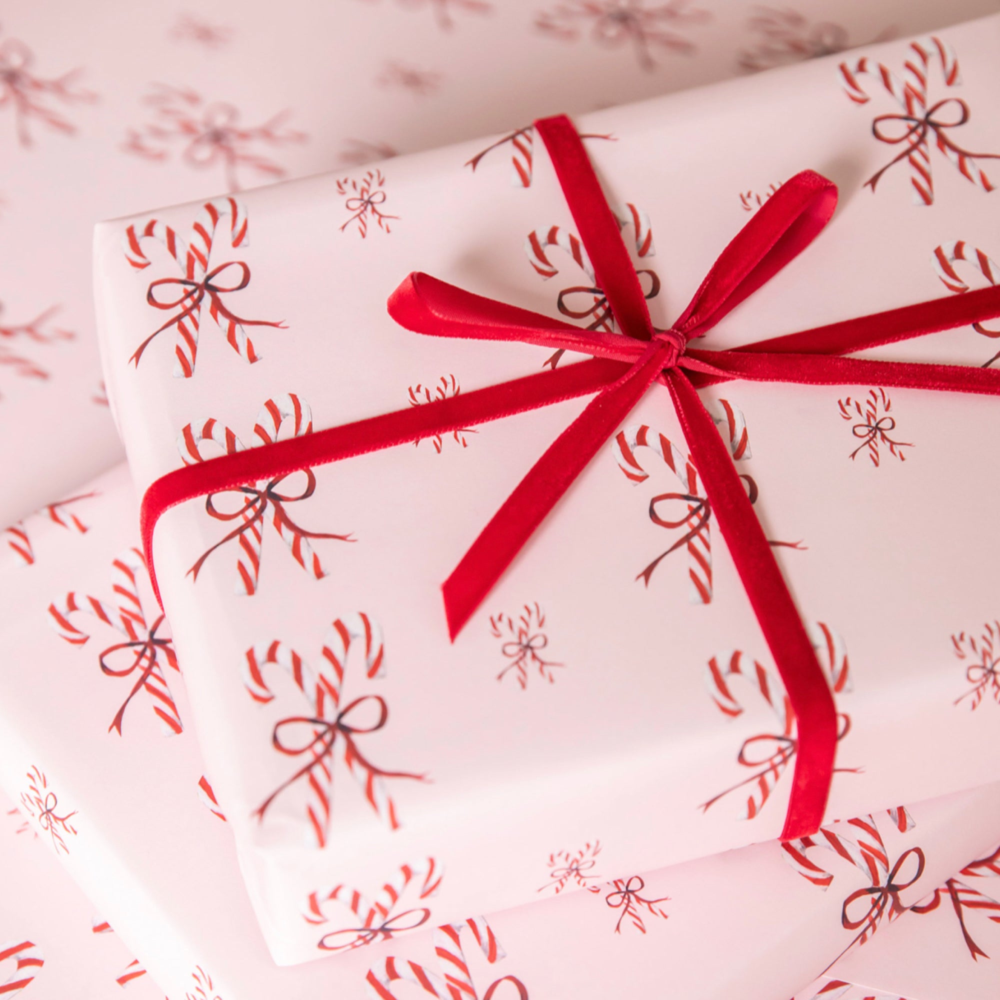 Luxury Christmas Wrapping Paper by Memo Press with a watercolour illustration two Candy Canes tied with a red bow made in Britain