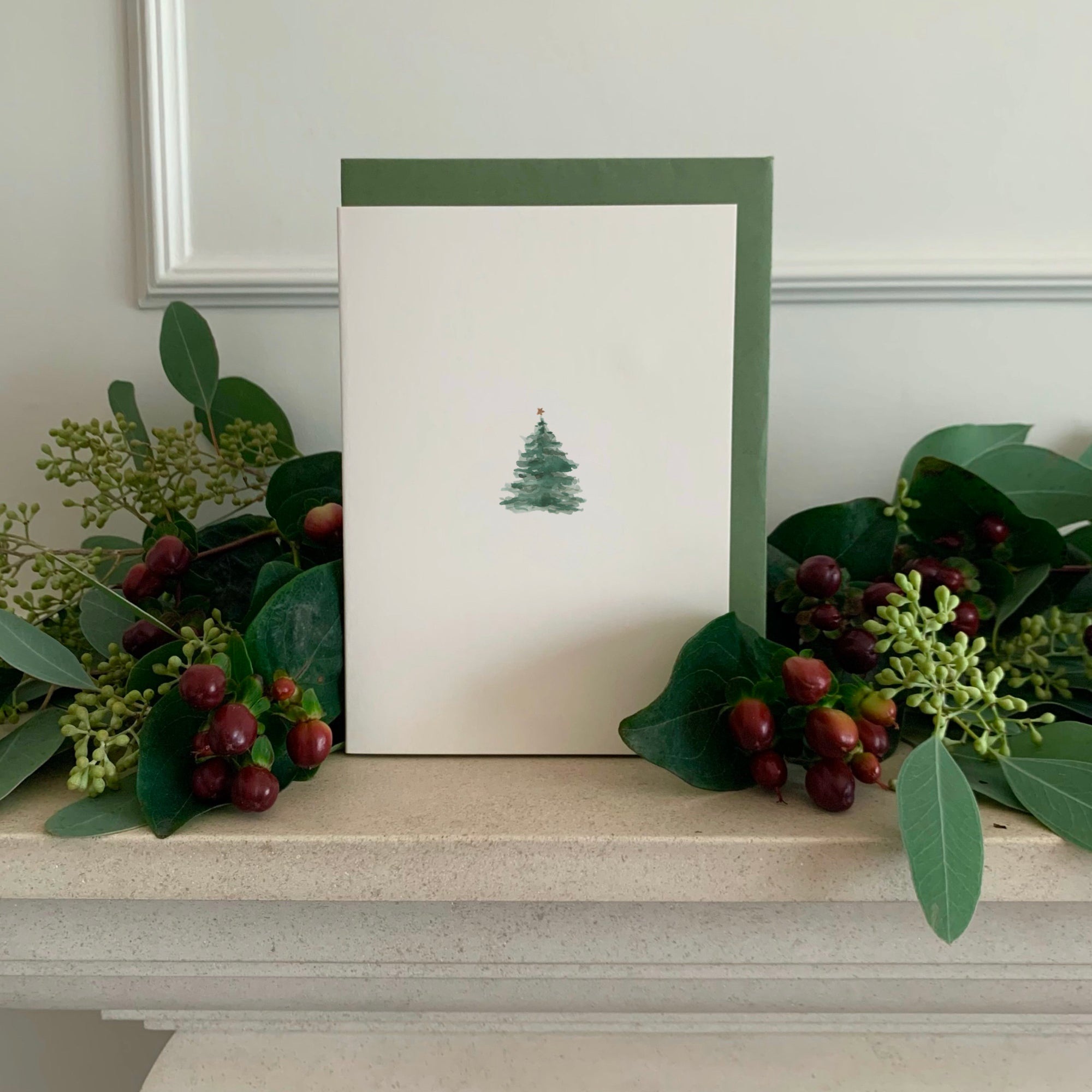 Luxury Christmas Card by Memo Press with a watercolour illustration of a traditional Christmas Tree with a single star on top and comes with a olive green envelope made in Britain
