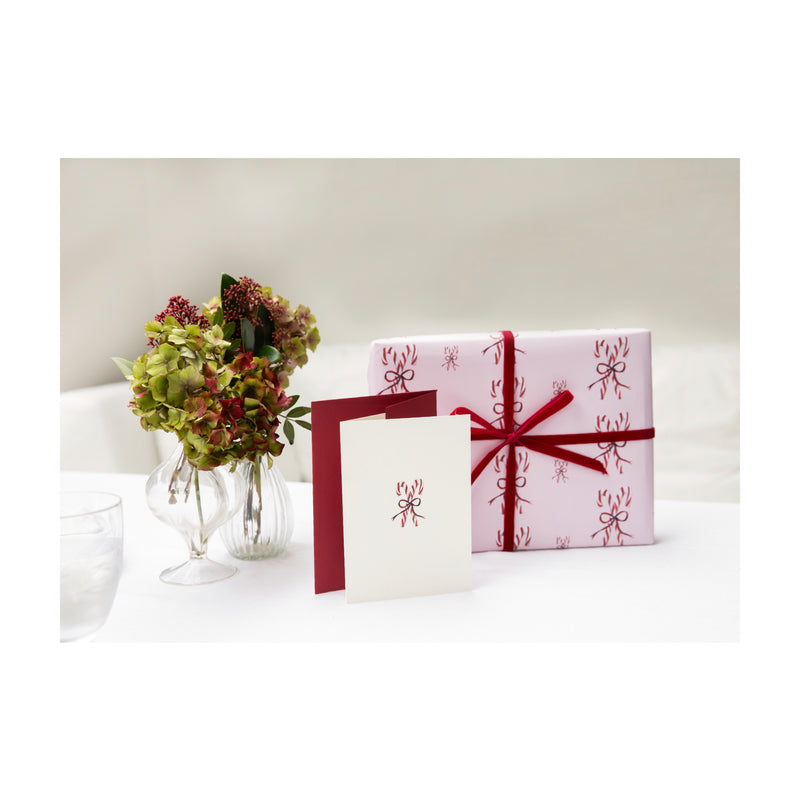 Luxury Christmas Card with an illustration of a pair of candy canes tied in a bow by Memo Press