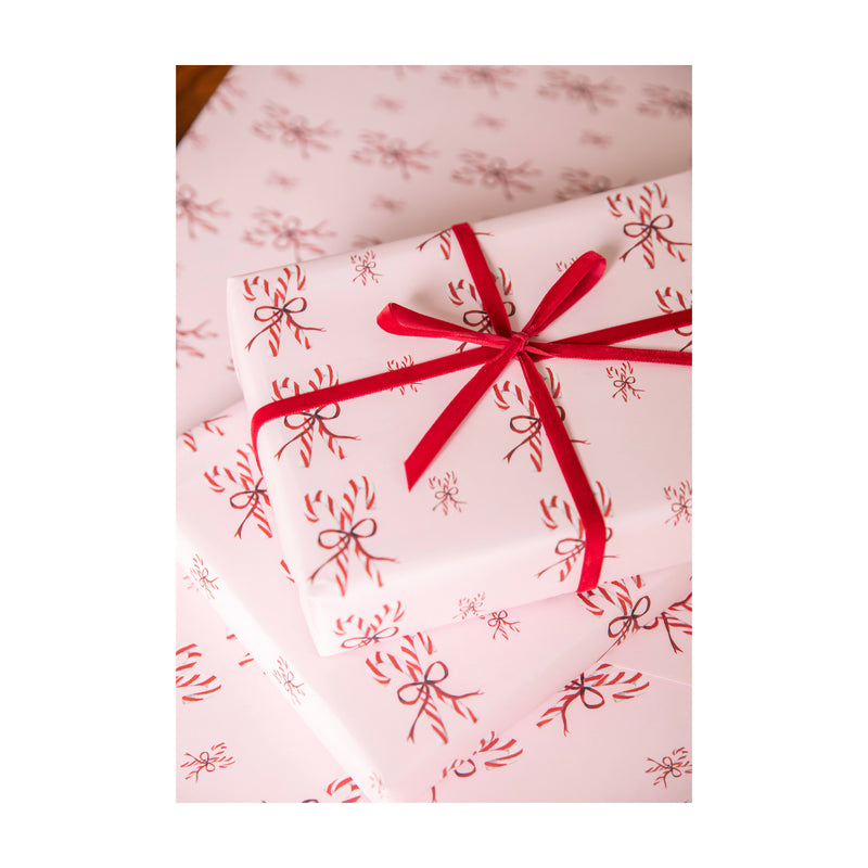 Luxury Christmas Wrapping Paper with watercolour illustrations of Candy Canes tied in a bow on shell pink paper by Memo Press