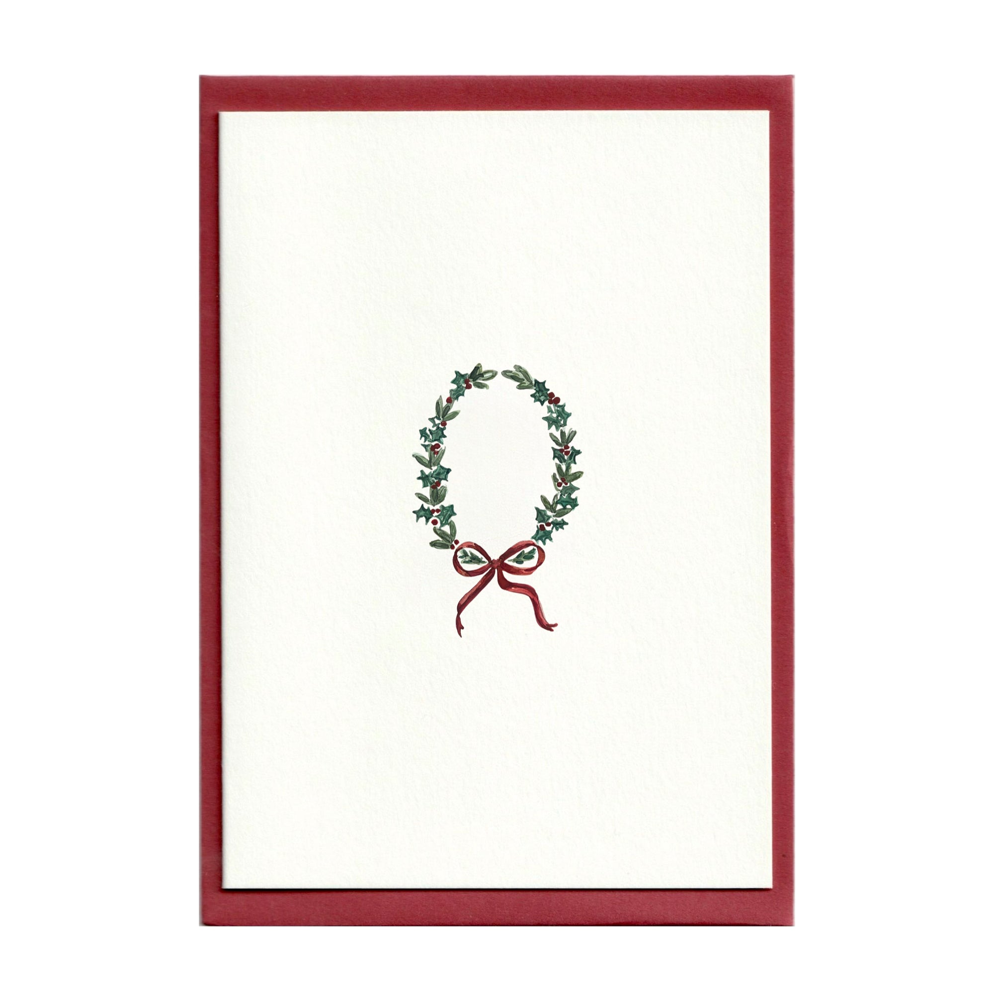 Watercolour illustration of a holly Wreath tied with a burgundy bow, comes with scarlet envelopes by Memo Press made in Great Britain.