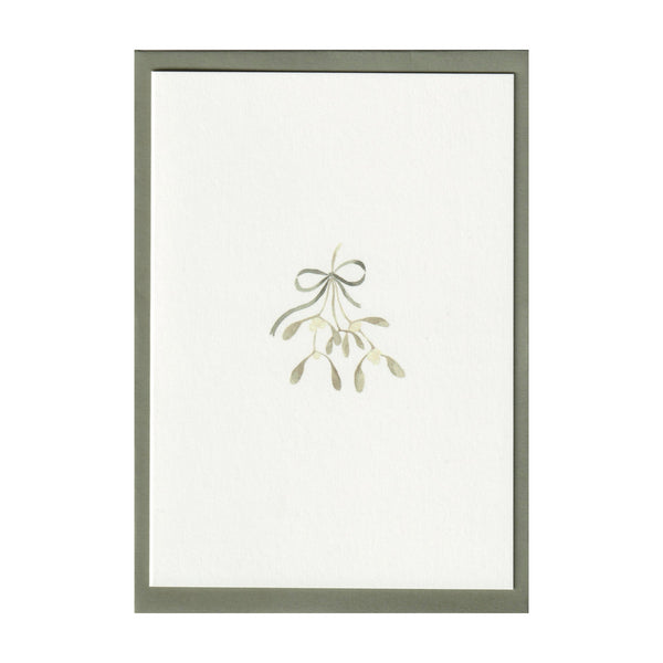 Luxury Christmas Card by Memo Press with a watercolour illustration of mistletoe tied with a ribbon tied with a bow and comes with a green envelope made in Britain