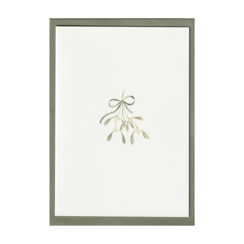 Luxury Christmas Card by Memo Press with a watercolour illustration of mistletoe tied with a ribbon tied with a bow and comes with a green envelope made in Britain