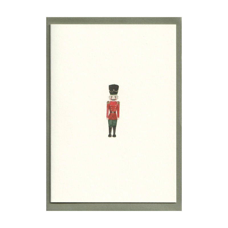 Luxury Christmas Card by Memo Press with a watercolour illustration of a Nutcracker solider and comes with a green envelope made in Britain